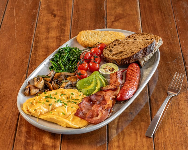 Big Brekky plate with scrambled eggs, kransky, Streaky Bacon, mushrooms, spinach, cherry tomatoes, avocado, hash brown and sourdough